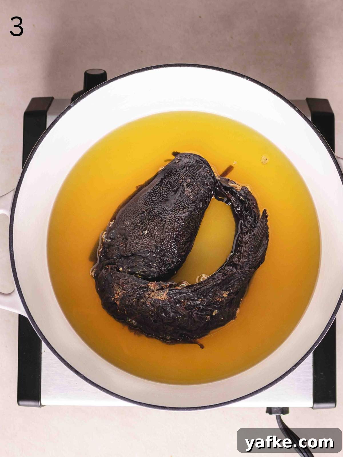 Dried cat fish in a pot with stock.
