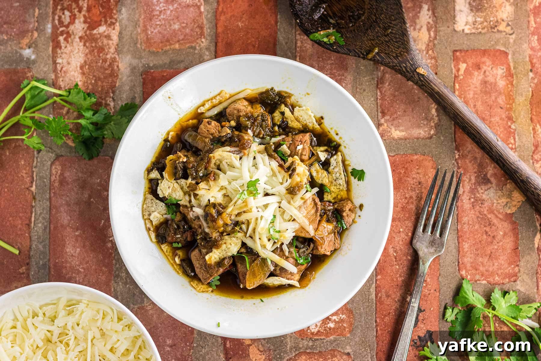 Slow Cooker Pork Chile Verde: Tender Pork in Tomatillo Sauce 17 Overhead view of pork chile verde in a white bowl