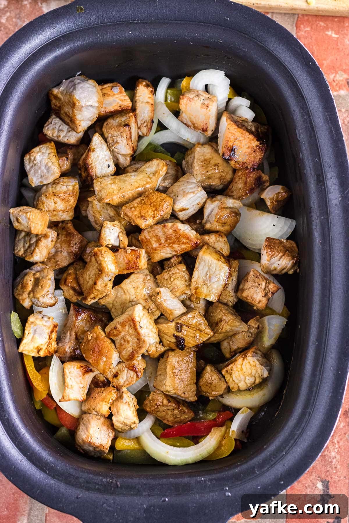 Slow Cooker Pork Chile Verde: Tender Pork in Tomatillo Sauce 6 The seared pork chunks added to the slow cooker.