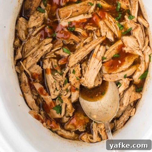 Overhead view of shredded Dr Pepper pulled pork in the crockpot.