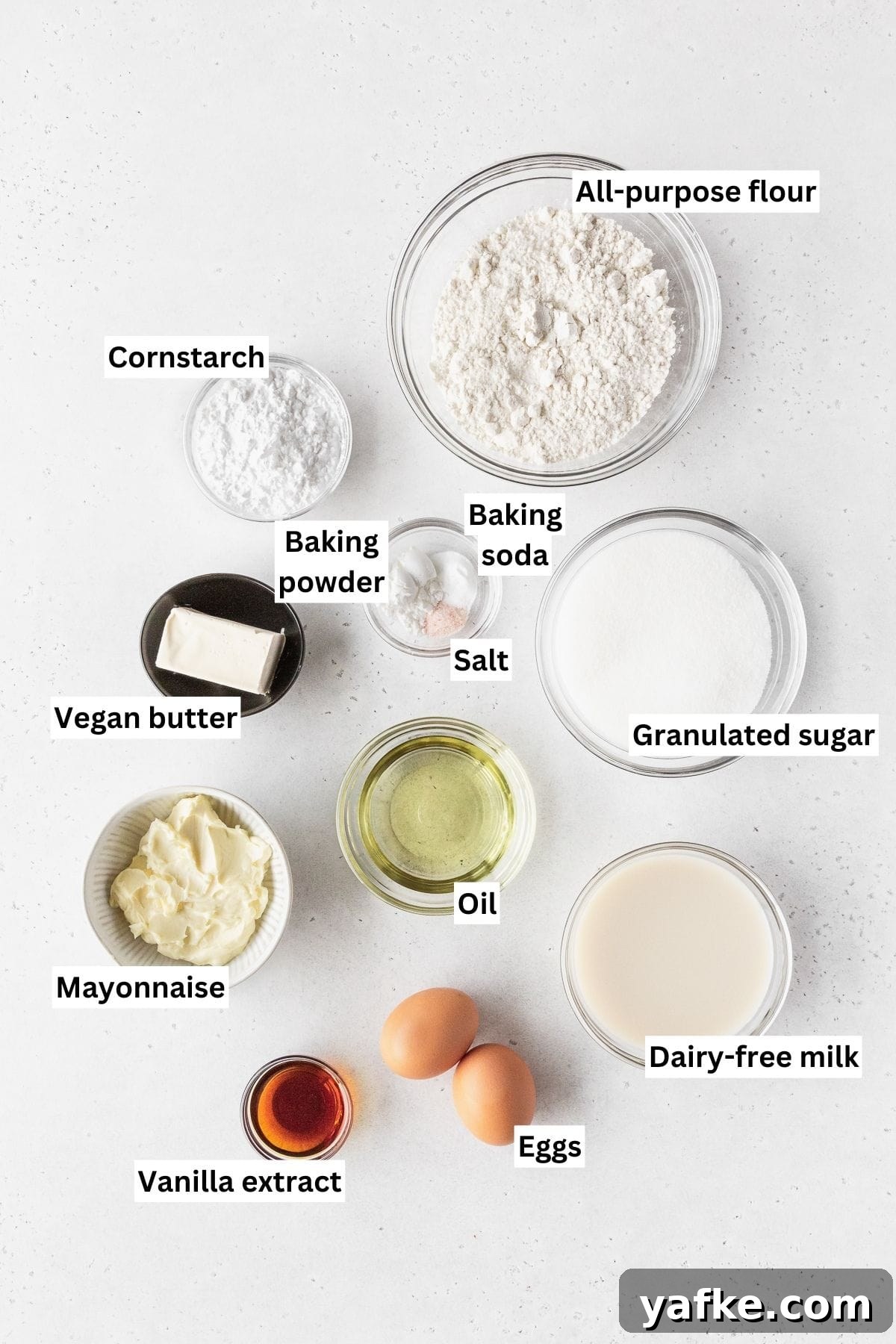 How to Make Dairy-Free Cupcakes 3 Ingredients for making dairy-free vanilla cupcakes laid out on a white table.