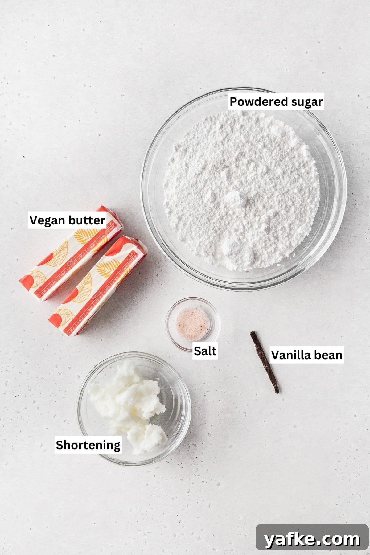 How to Make Dairy-Free Cupcakes 4 Ingredients for making vegan vanilla buttercream frosting laid out on a white table.