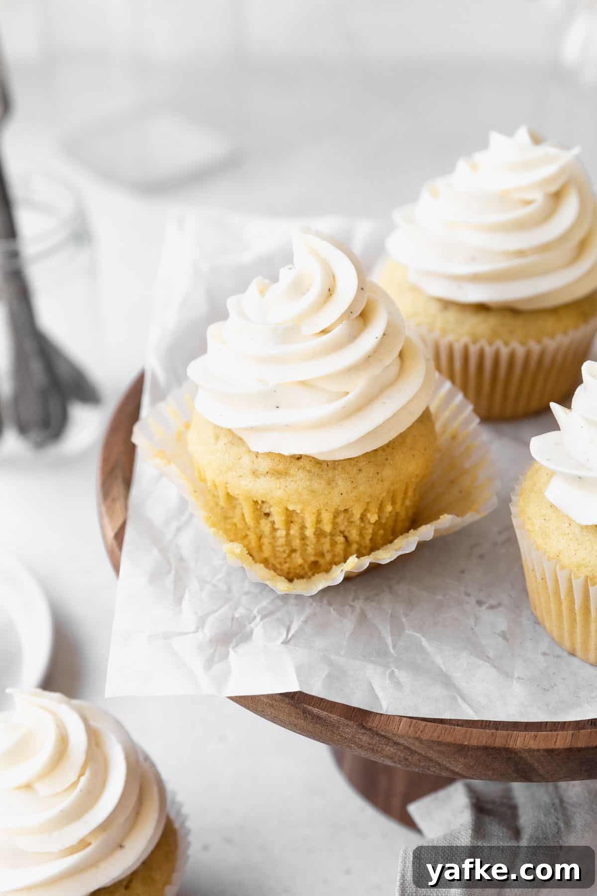 How to Make Dairy-Free Cupcakes 10 A dairy-free vanilla cupcake with the wrapper pulled off to expose the texture of the cake.