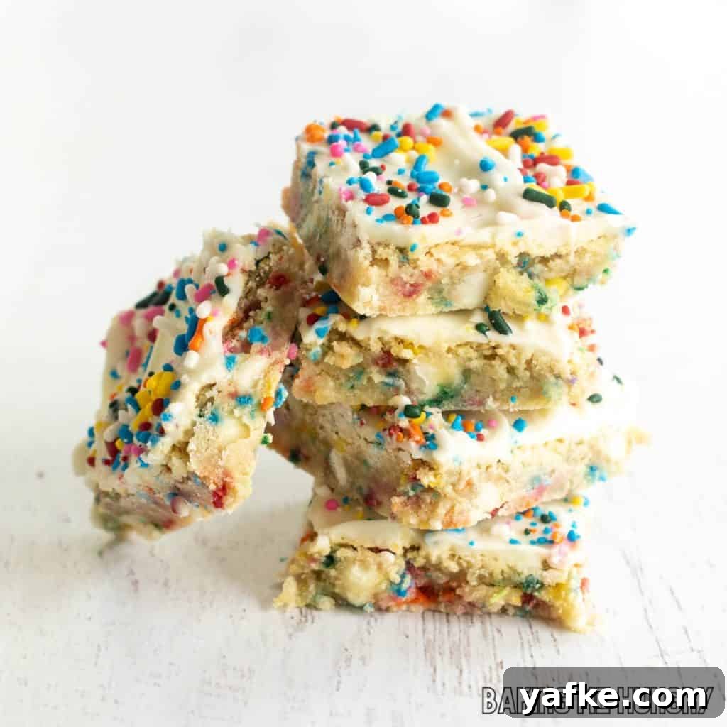 Birthday Cake Blondies Recipe with Sprinkles 3 stack of birthday cake blondies with one on his side