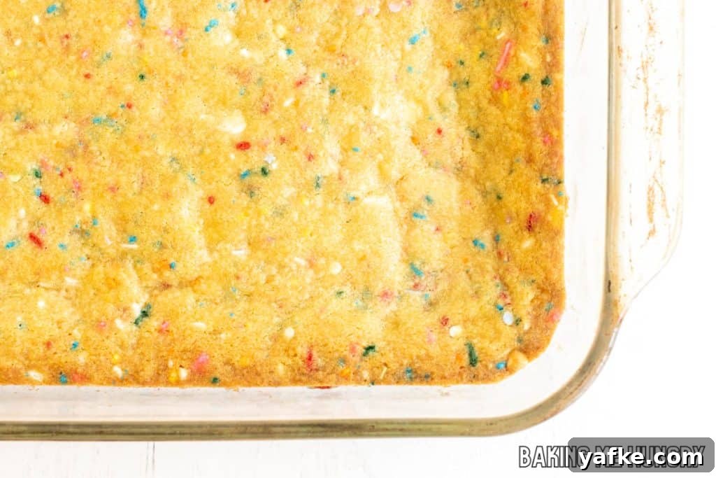 Birthday Cake Blondies Recipe with Sprinkles 10 baked blondies in pan close up