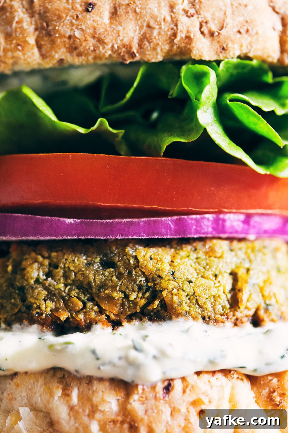 Crispy Falafel Tahini Burgers with Refreshing Tzatziki 4 Side view of burger toppings close up