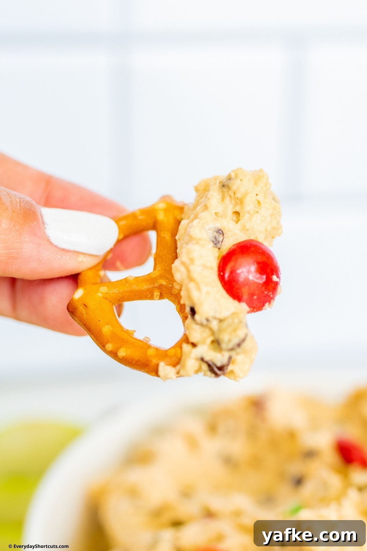No-Bake Monster Cookie Dough Dip Recipe for Parties 2 cookie dough dip on a pretzel