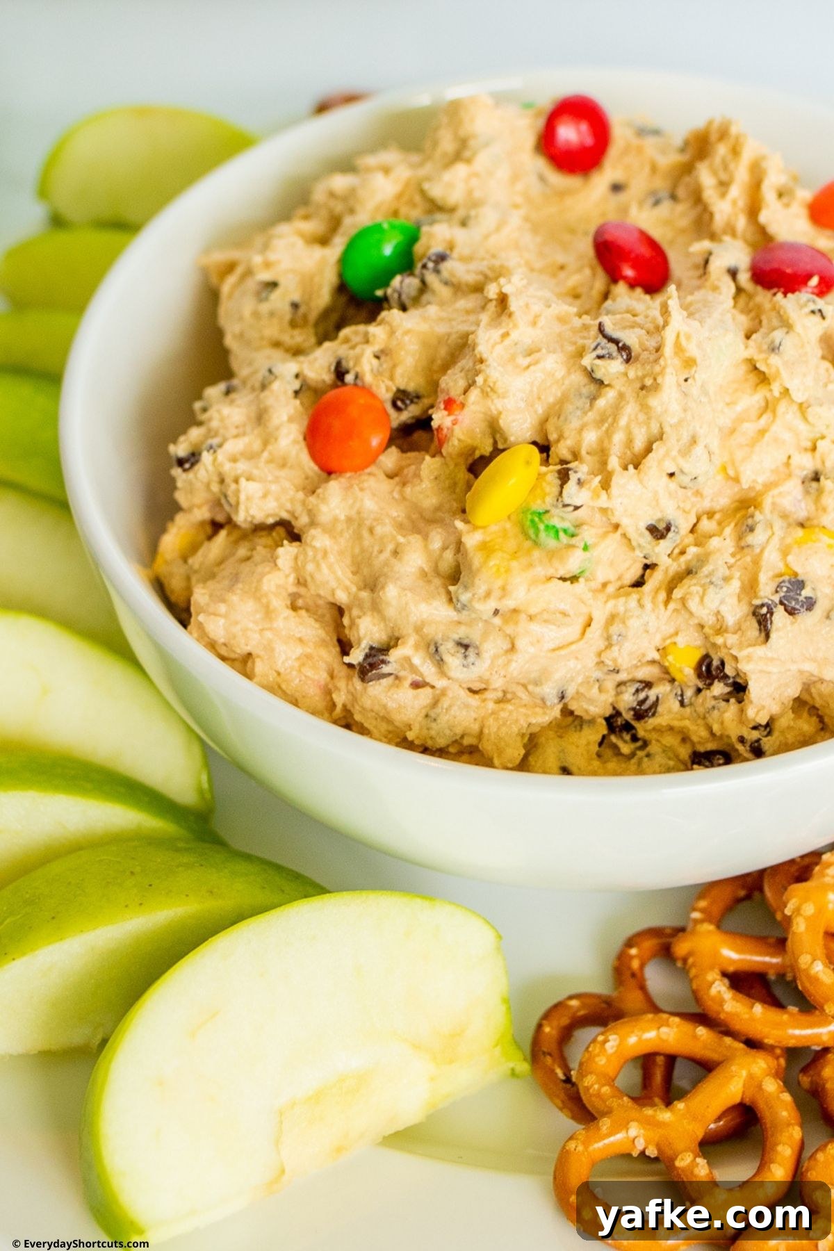 No-Bake Monster Cookie Dough Dip Recipe for Parties 3 edible cookie dough in a bowl with M&M's