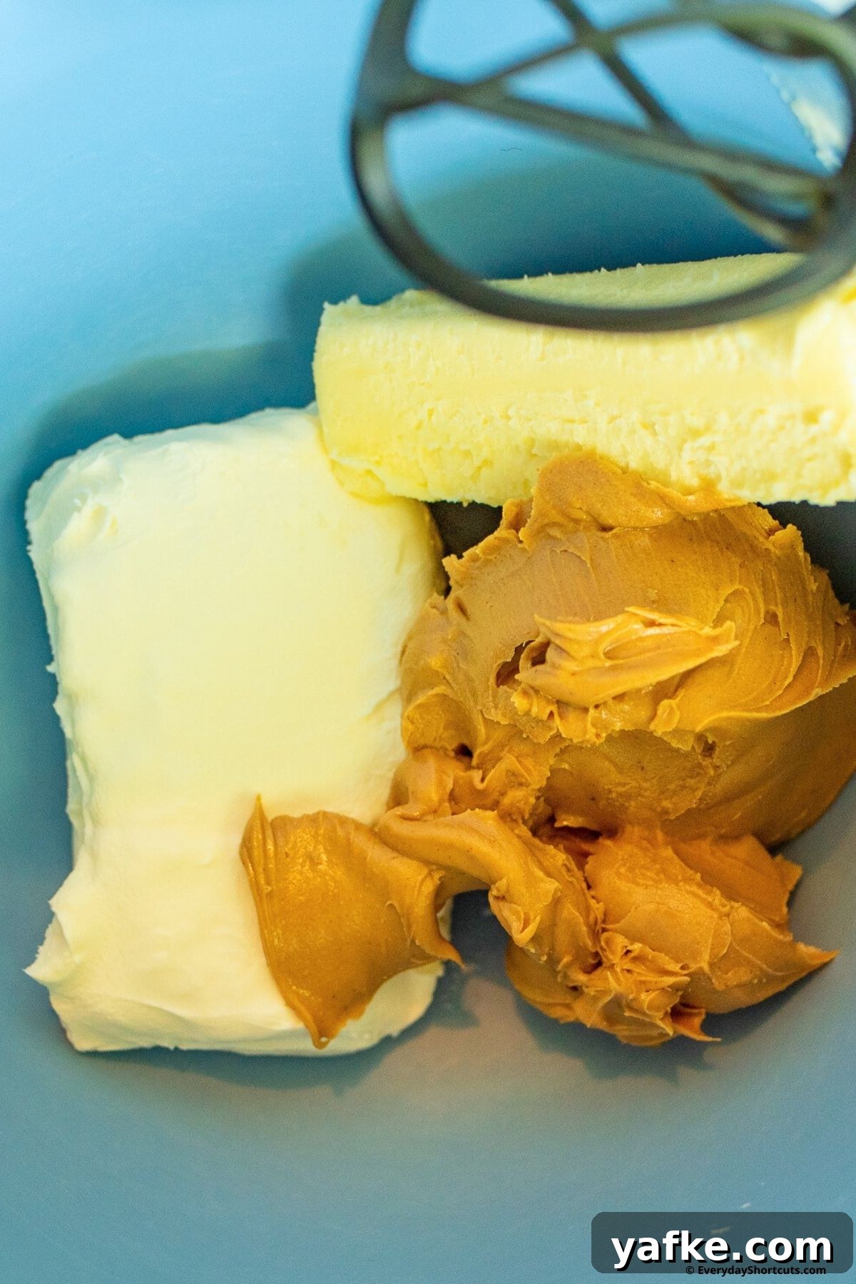 No-Bake Monster Cookie Dough Dip Recipe for Parties 5 peanut butter butter and cream cheese in a bowl