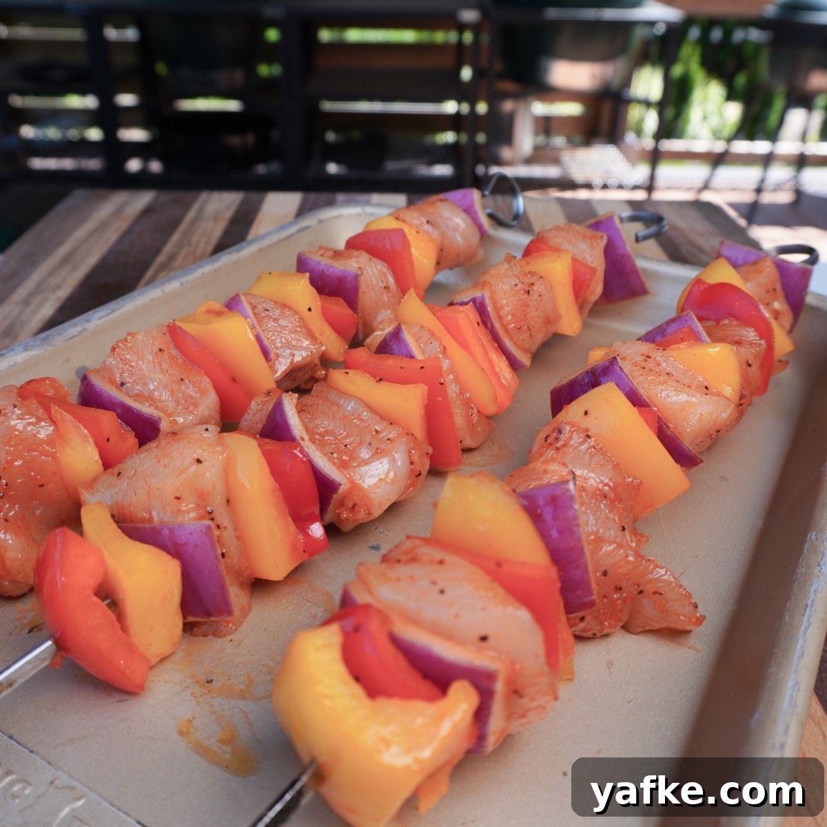 Juicy Grilled Chicken Skewers with Lemon and Herbs 4 Chicken pieces and vegetables tossed with seasoning in a bowl
