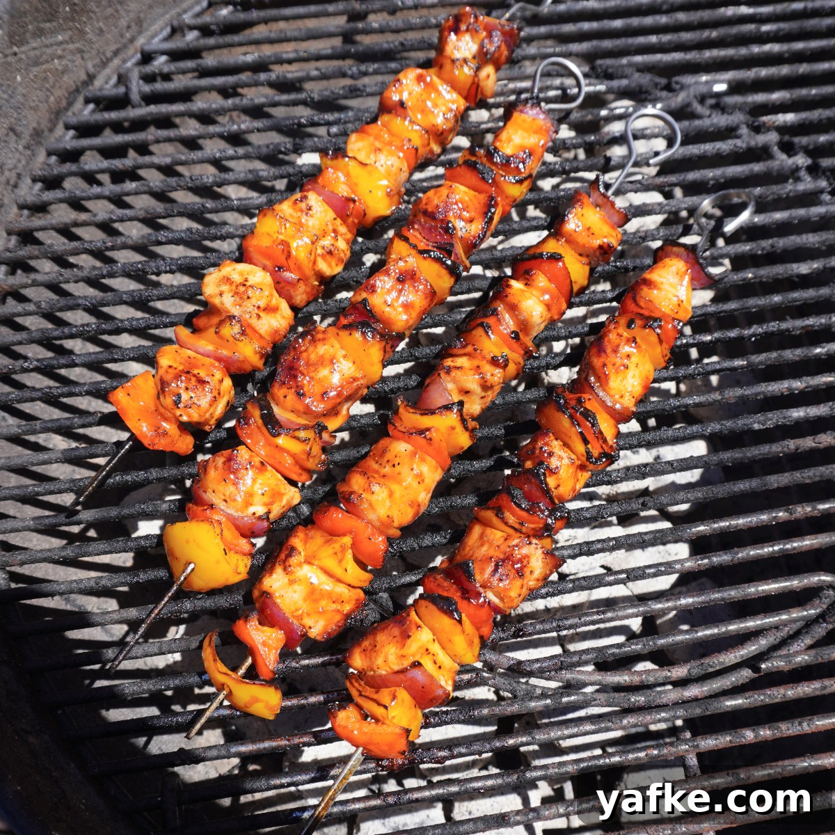 Juicy Grilled Chicken Skewers with Lemon and Herbs 6 Grilled chicken skewers on the barbecue