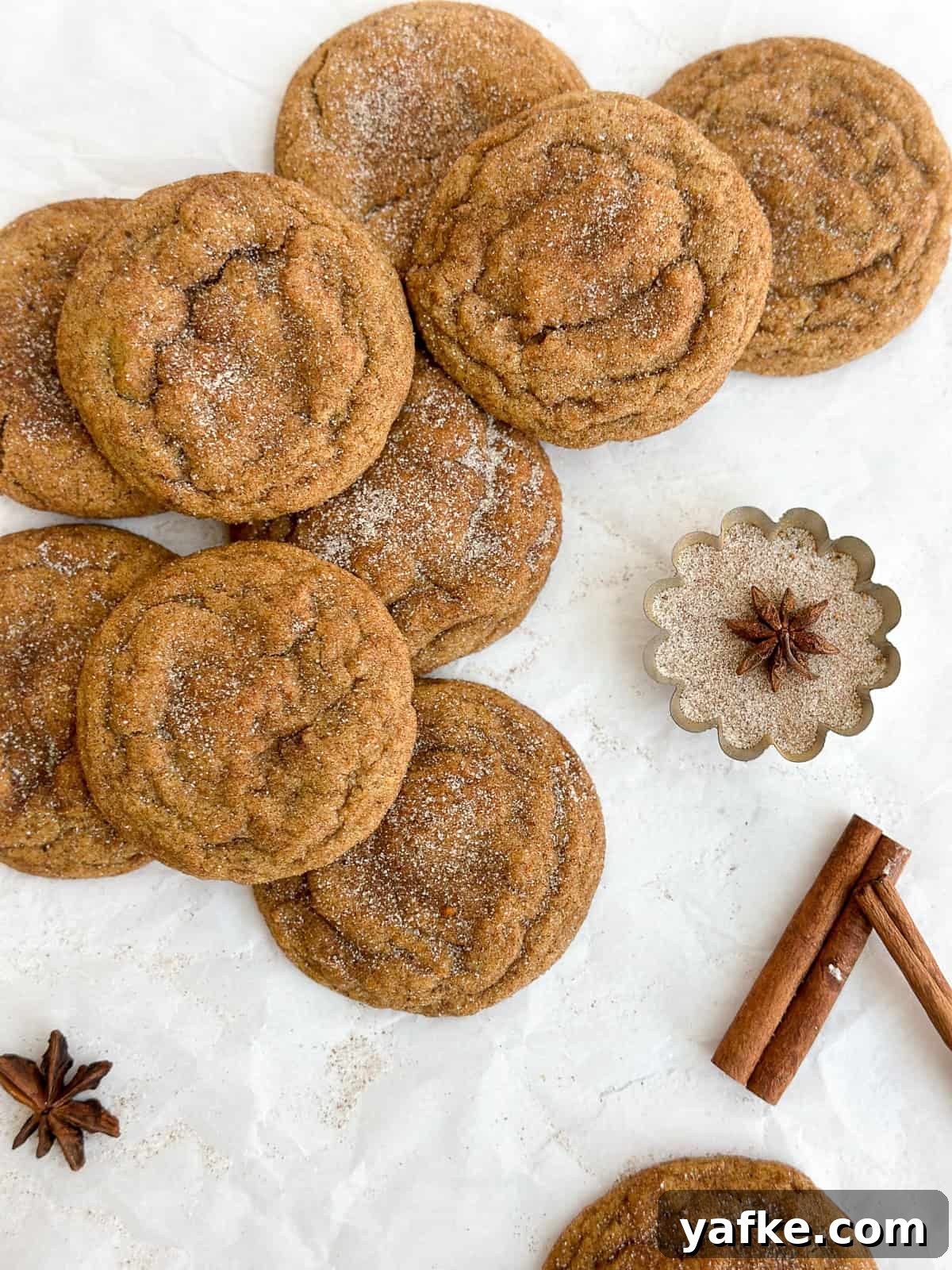 Chewy Brown Butter Pumpkin Snickerdoodles Recipe 2 a group of browned butter pumpkin snickerdoodles stacked on top of each other.