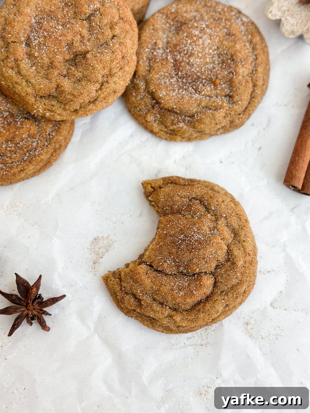 Chewy Brown Butter Pumpkin Snickerdoodles Recipe 3 a close up of a brown butter pumpkin snickerdoodle with a bite missing.
