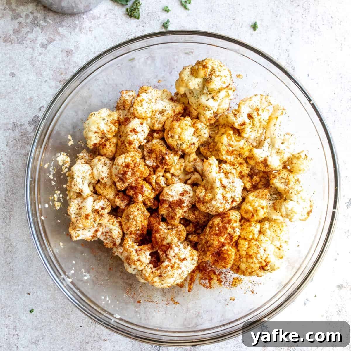 Grilled Halloumi Farro Bowls with Maple Dijon Dressing Recipe 4 Cauliflower seasoned and oiled in a bowl.