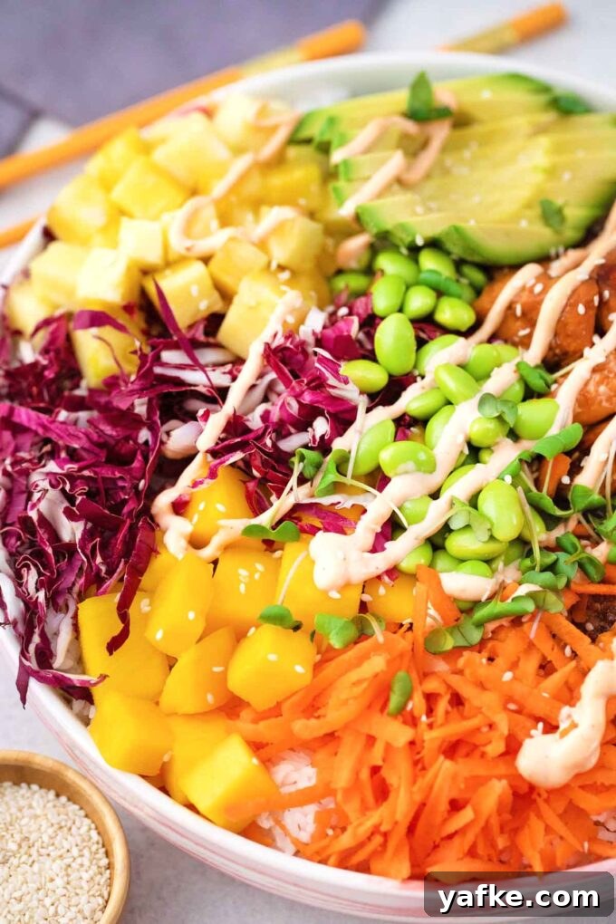 Seared Salmon Poke Bowl Recipe with Soy-Ginger Glaze 3 cooked salmon poke bowl with shredded red cabbage shredded carrot edamame pineapple mango