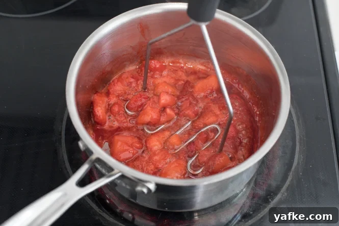 Mashing strawberries for strawberry sauce Mashing strawberries for strawberry sauce