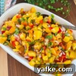 peach salsa in bowl diagonal on cutting board