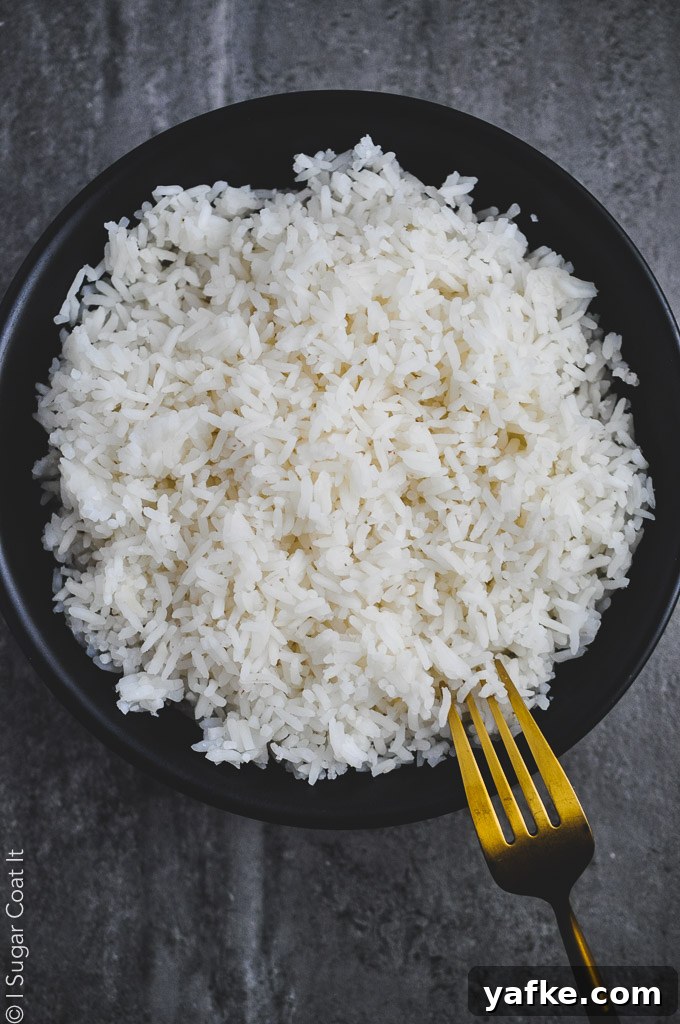 black bowl on a stone counter filled with rice cooked in coconut water, sous vide | i sugar coat it
