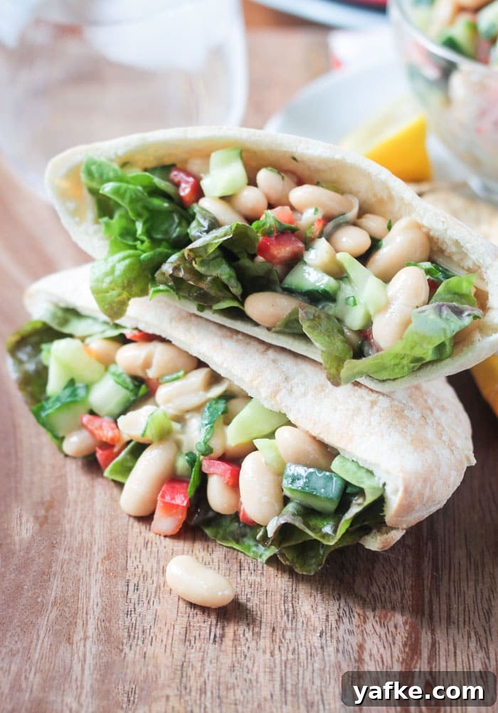 2017's Most Popular Plant-Based Recipes 6 Two pita pockets stacked on top of each other and stuffed with White Bean Salad w/ cucumbers, red peppers, and red leaf lettuce.