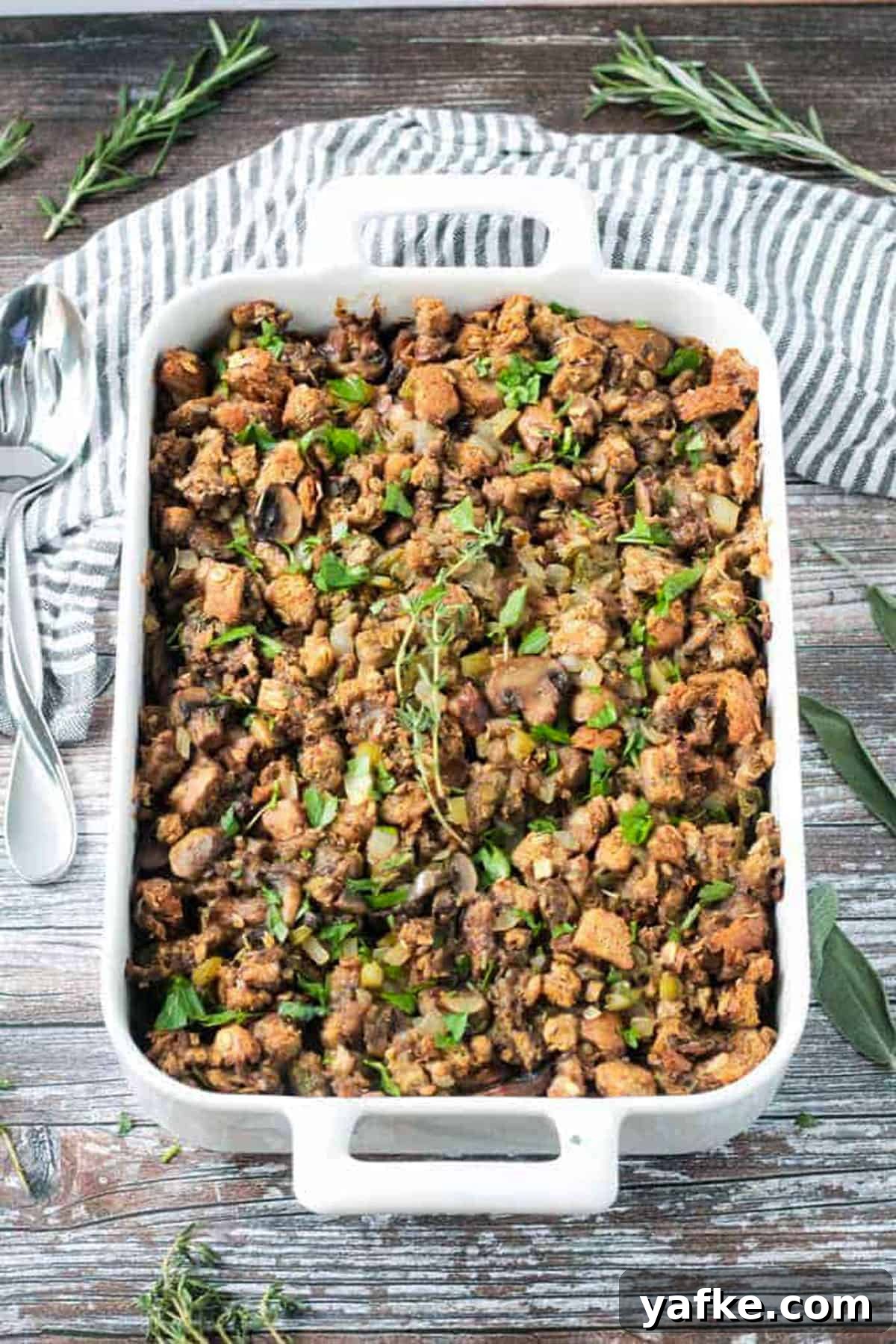 2017's Most Popular Plant-Based Recipes 8 Finished dish of vegan stuffing with mushrooms in a white baking dish.