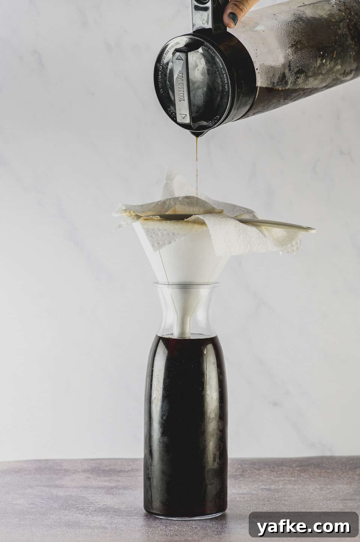 Cold Brew Coffee at Home: Smooth Concentrate in 12 Hours 4 filter cold brew coffee through a paper towel lined funnel