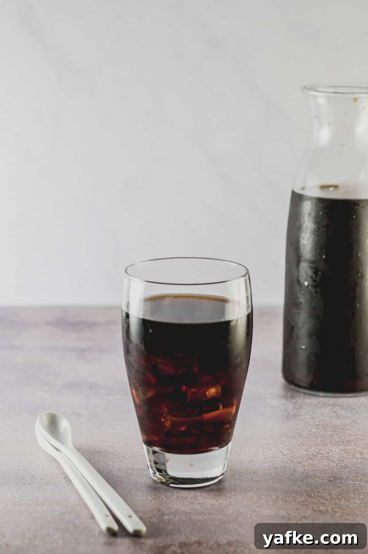 Cold Brew Coffee at Home: Smooth Concentrate in 12 Hours 7 a cup of cold brew and a pitcher