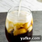 Cold Brew Coffee at Home: Smooth Concentrate in 12 Hours 8 pouring milk into a glass of cold brew coffee
