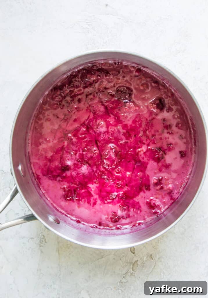 5-Ingredient Raspberry Chia Pudding Recipe 6 A pot with a pink raspberry sauce in it.