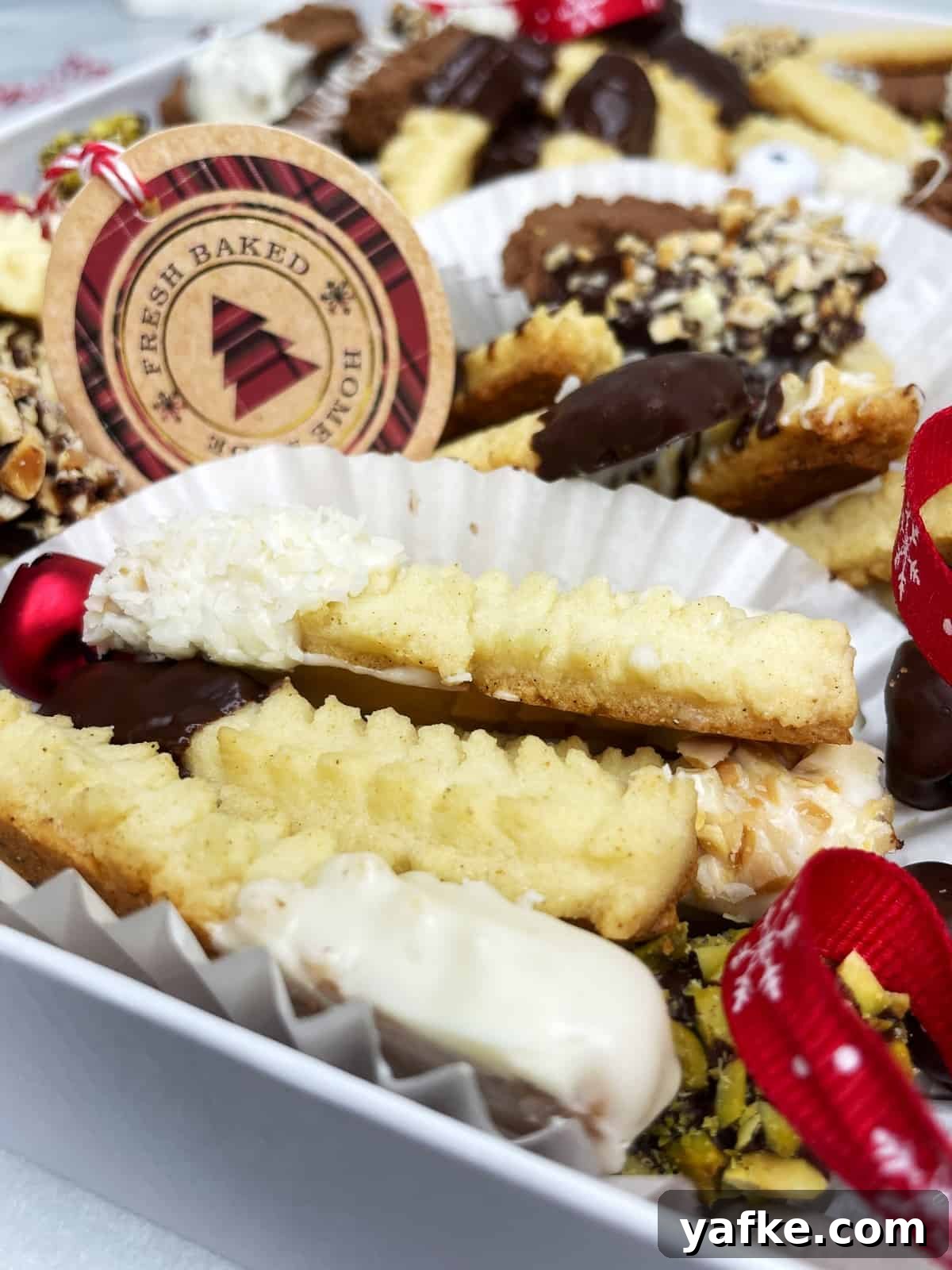 DIY Christmas Cookie Box: Step-by-Step Gift Guide 3 Spritz bredele cookies covered with chocolate in a Christmas cookie box