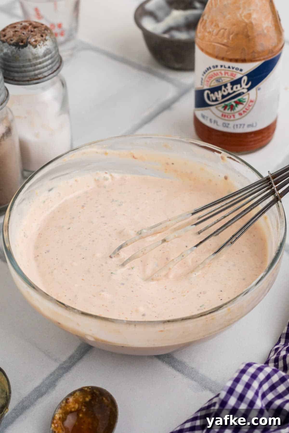 Creamy Remoulade Sauce Recipe for Seafood and Sandwiches 2 A bowl of remoulade sauce, with a wire whip in it.