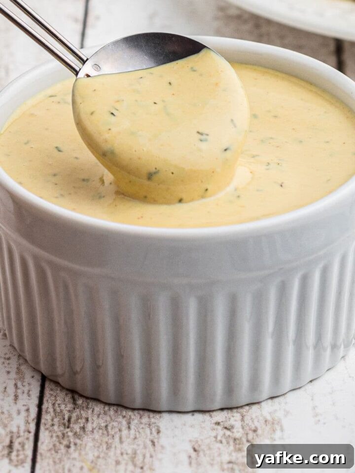 Close up of a bowl of Mcdonald's breakfast sauce recipe with a spoon digging in.