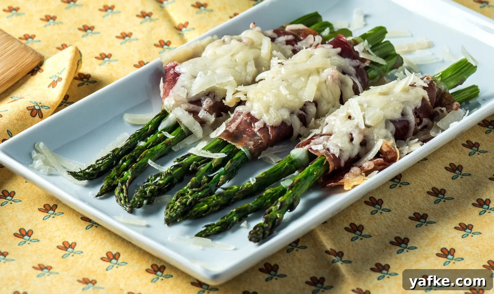 Asparagus with Ham and Manchego Recipe 2 Asparagus wrapped in ham with melted Manchego