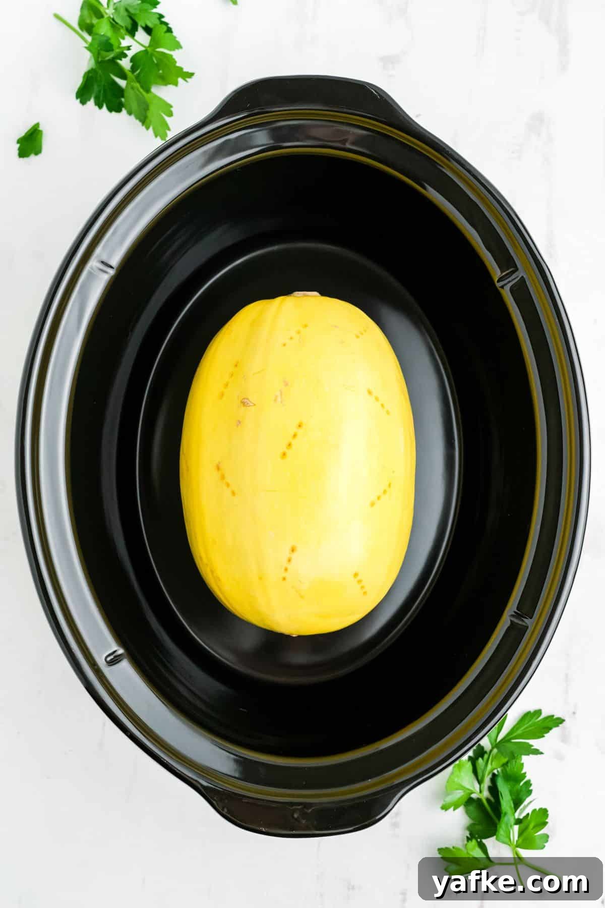 Slow Cooker Spaghetti Squash Recipe 4 Spaghetti squash in the slow cooker poked with holes.