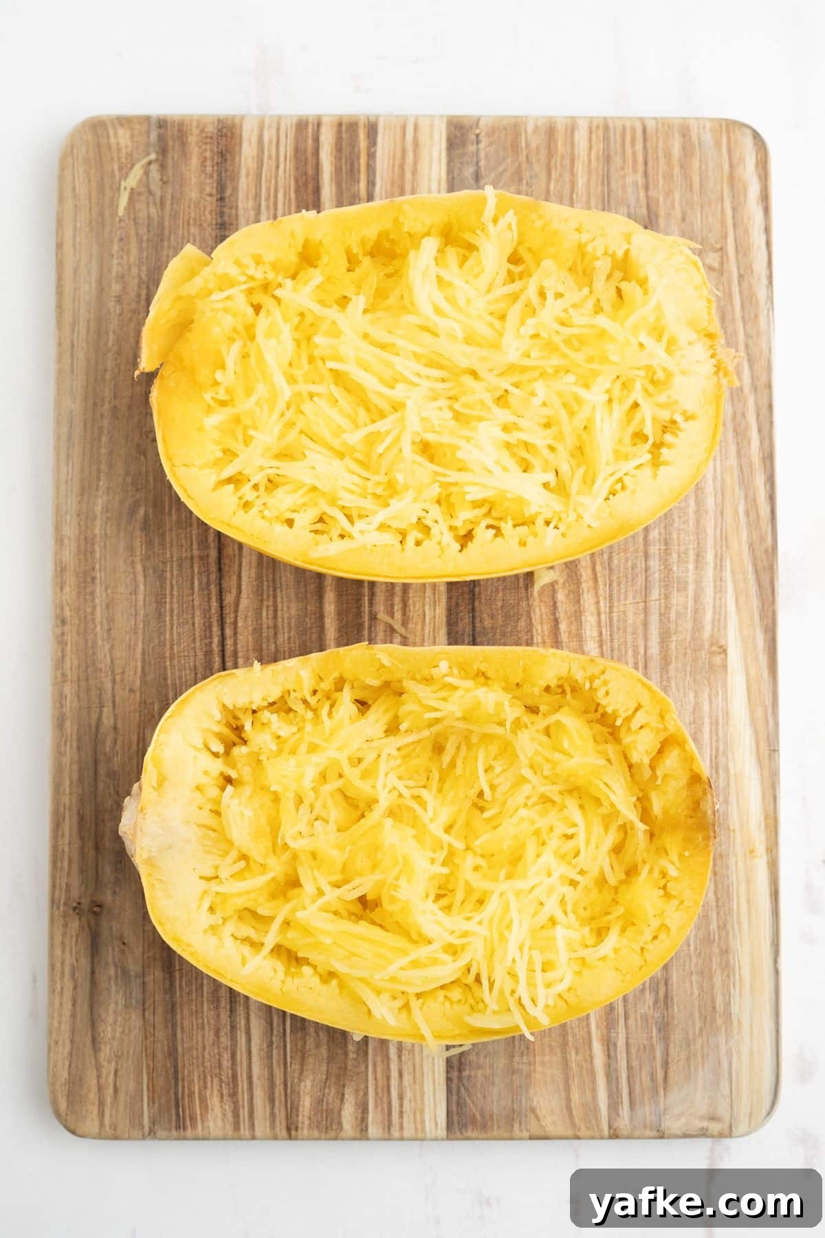 Slow Cooker Spaghetti Squash Recipe 7 Spaghetti squash with the insides pulled loose into strands of squash.