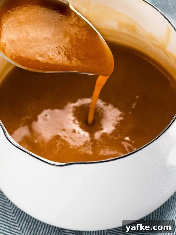 How to Make Quick Candied Chestnuts (Marrons Glacés) 8 Brown gravy made with beef stock poured from ladle.