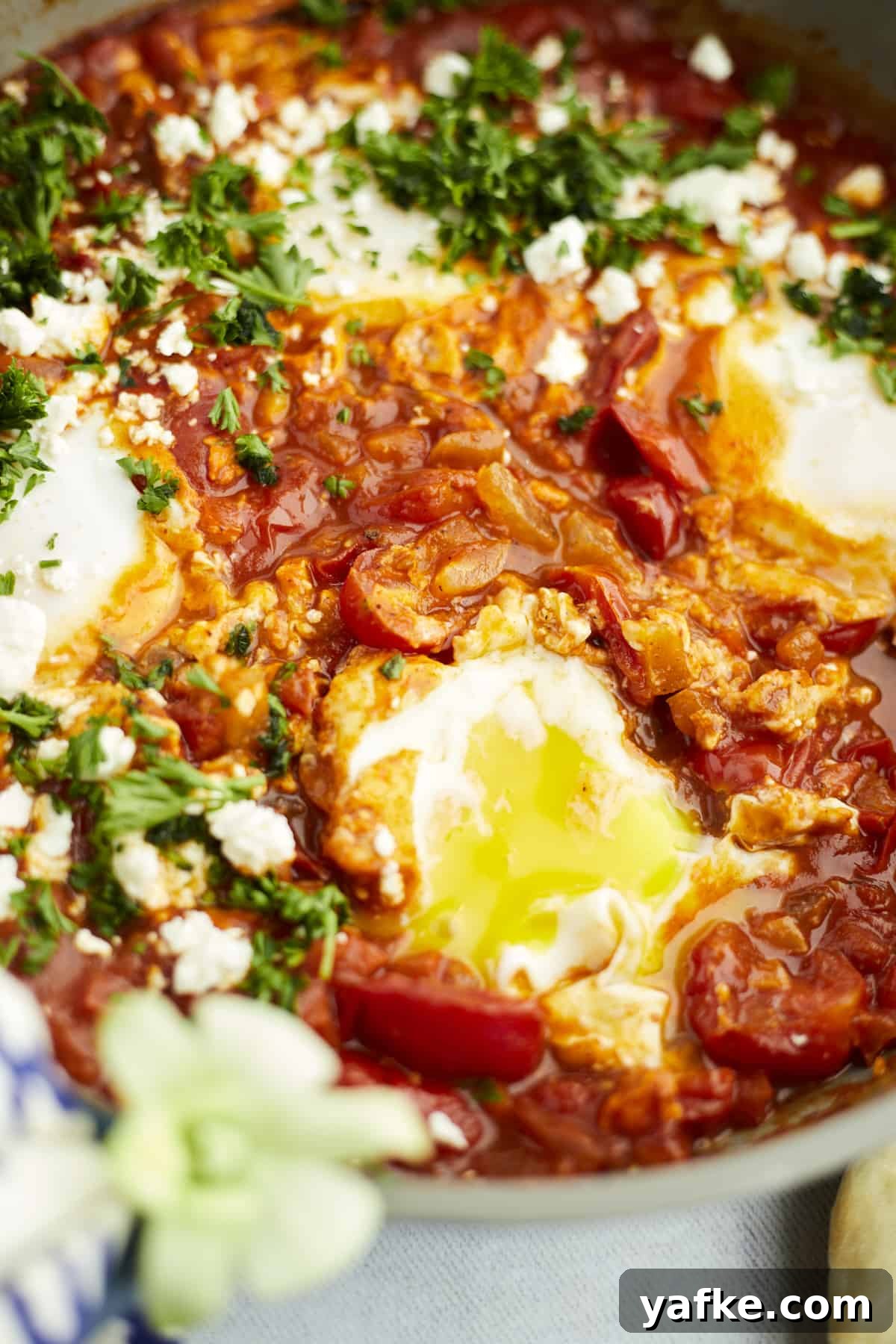 One-Pan Shakshuka with Feta and Fresh Herbs 9 close up image of easy shakshuka with feta