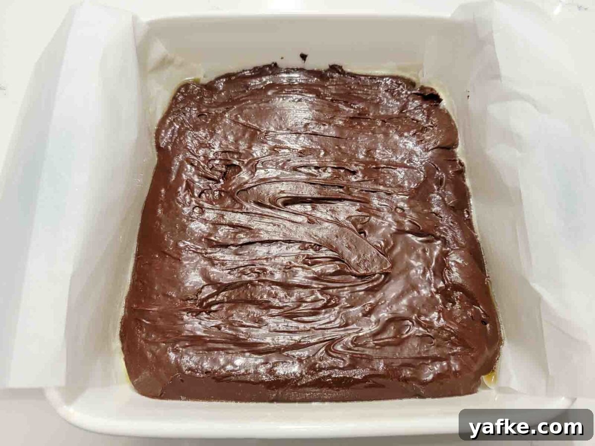 Decadent 4-Ingredient Chocolate Fudge 6 chocolate fudge spread in an 8x8 inch baking dish.