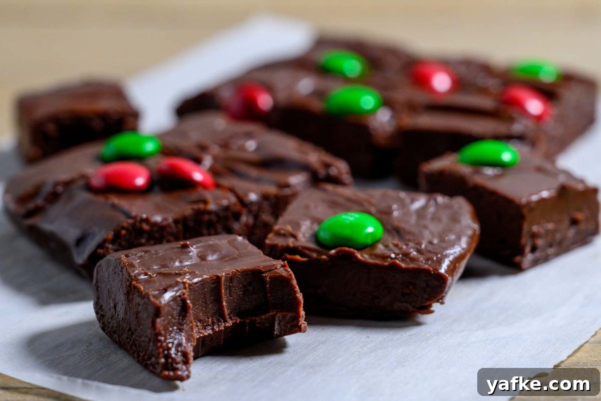 Decadent 4-Ingredient Chocolate Fudge 8 Easy Christmas Fudge with only 4 ingredients on parchment paper.