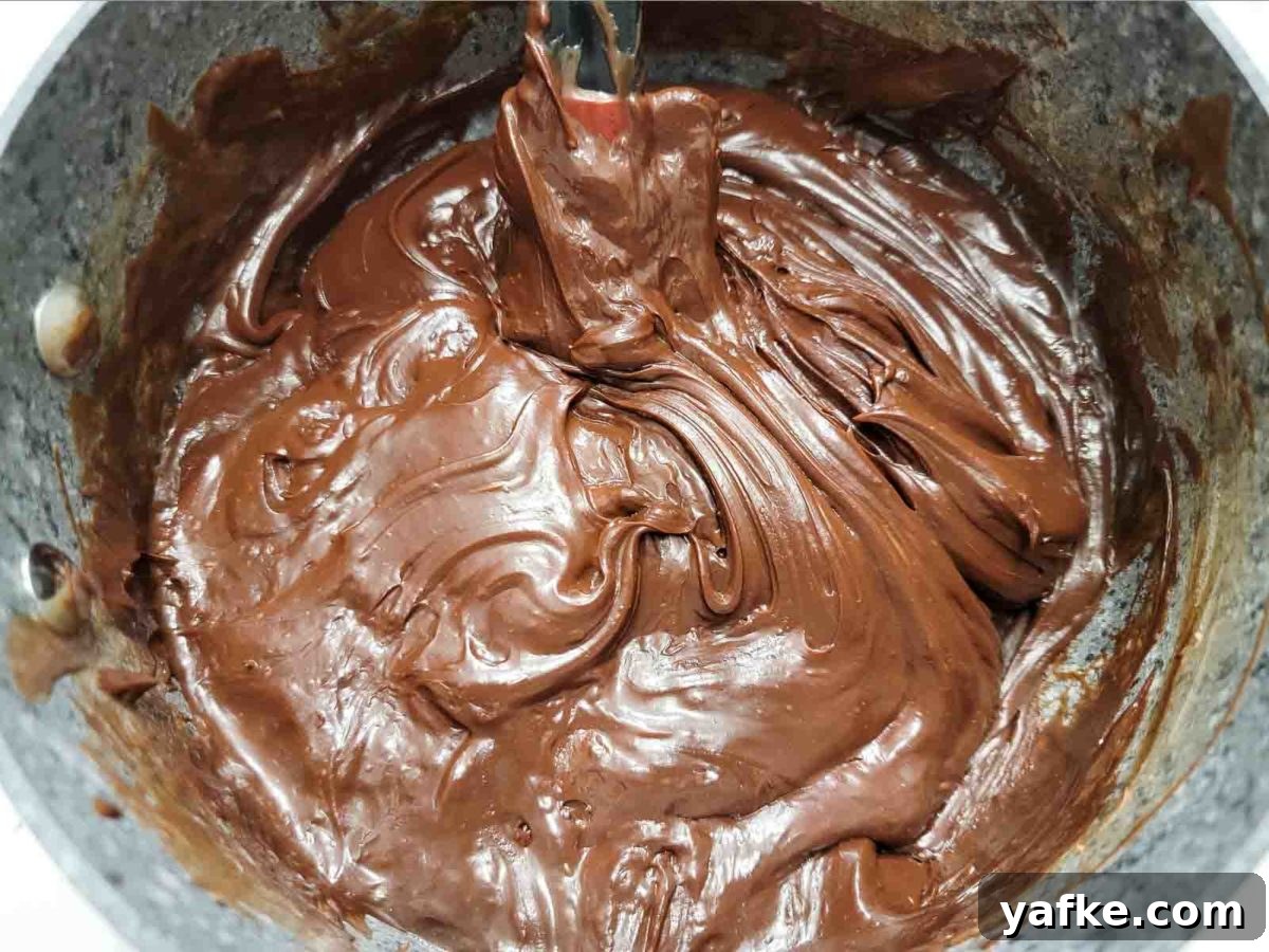 Decadent 4-Ingredient Chocolate Fudge 5 fudge cooking in a sauce pan.