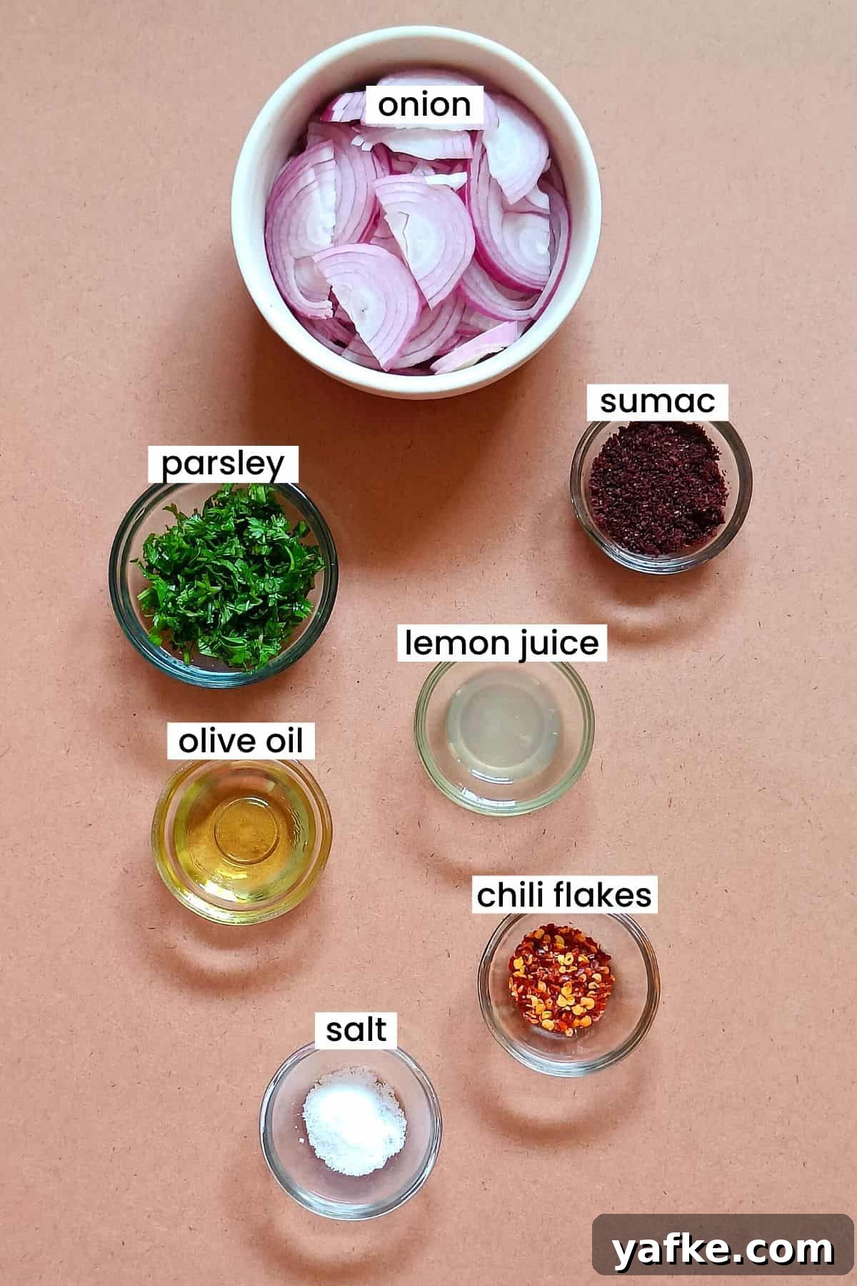 Turkish Sumac Marinated Red Onions Recipe 4 Image showing sumac onions ingredients placed on a light brown color background.