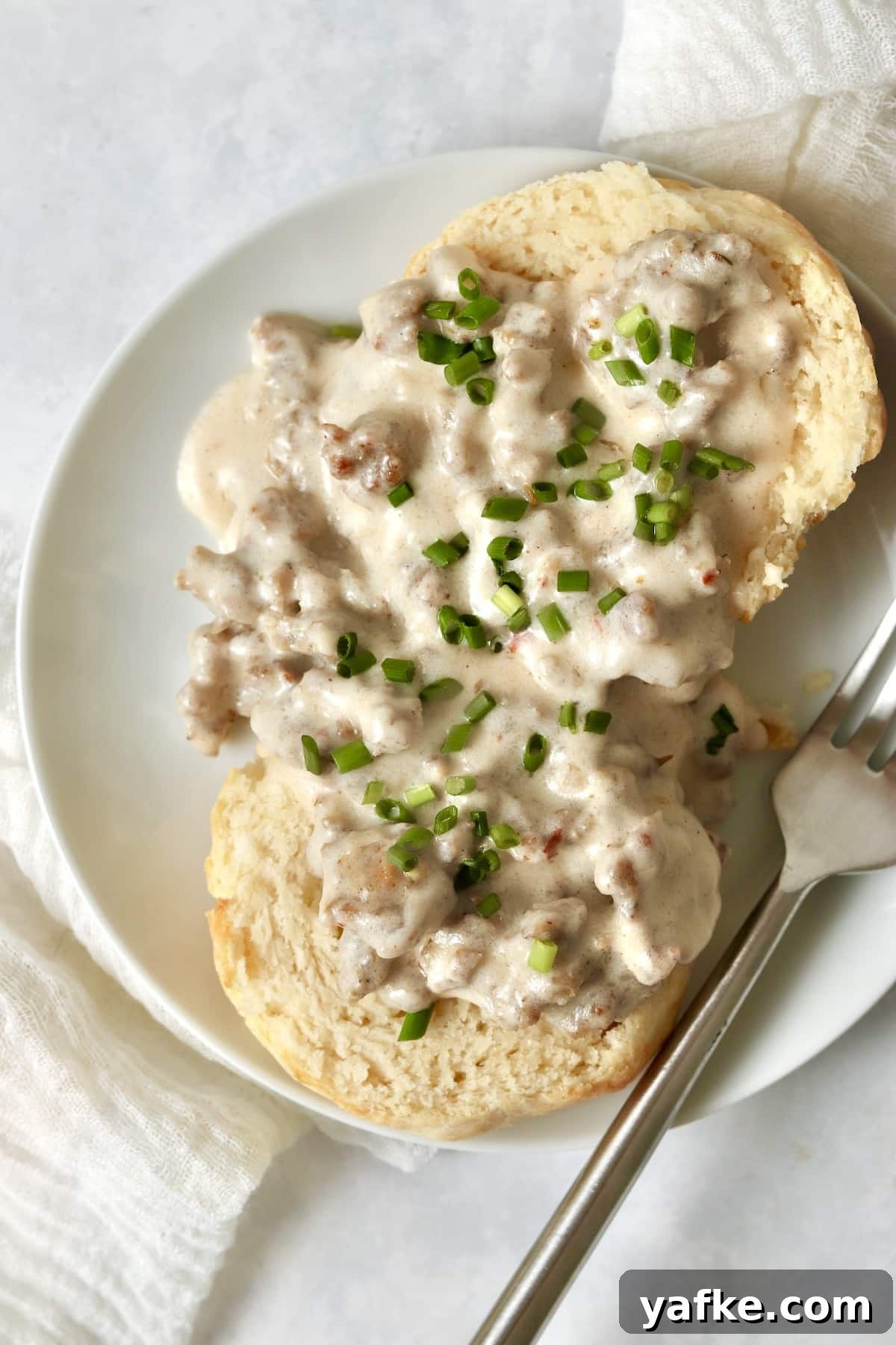 Single-Serve Biscuits and Sausage Gravy for One 2 Single serve biscuits and gravy on a small plate.