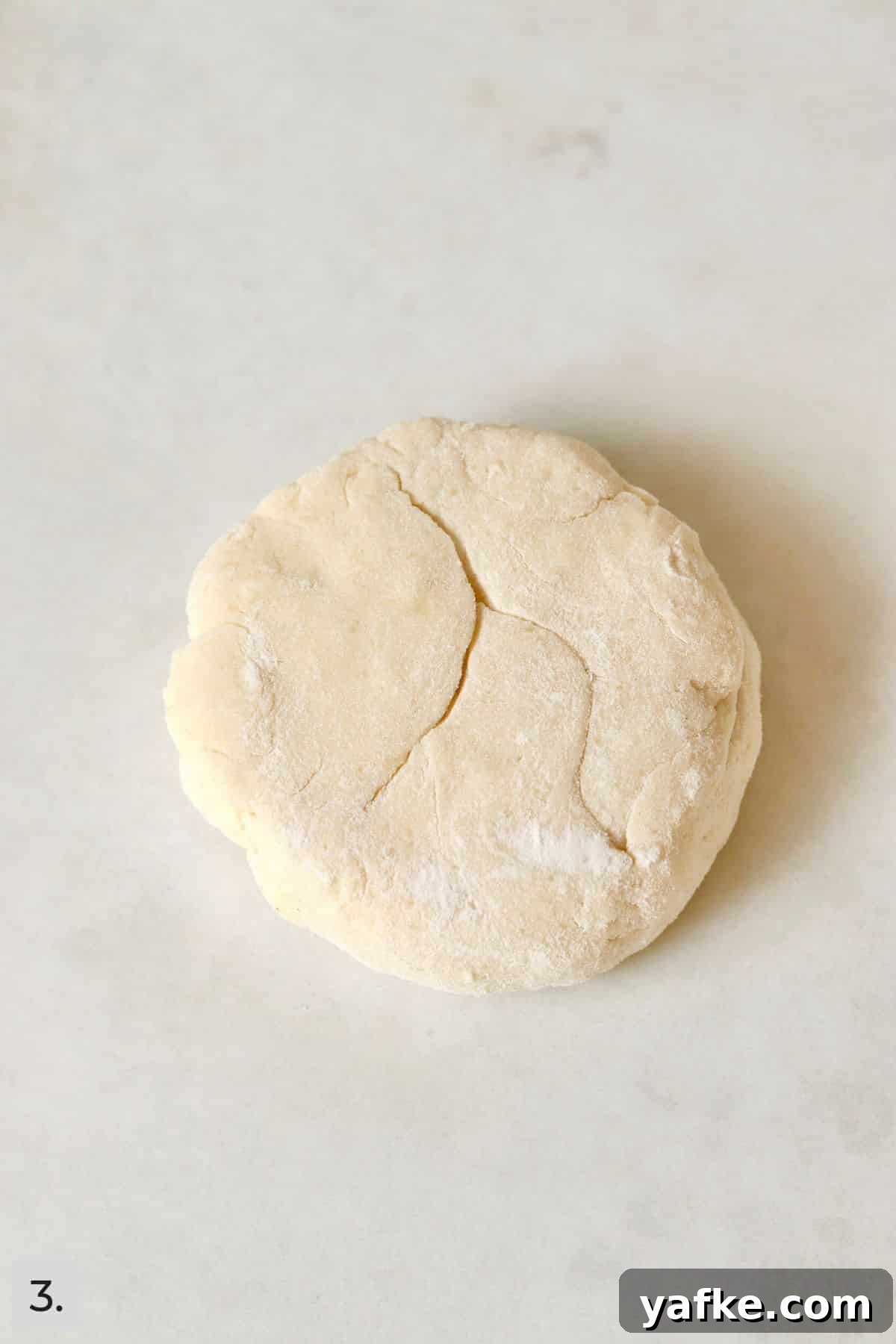 Single-Serve Biscuits and Sausage Gravy for One 6 Single biscuit on parchment paper before baking.