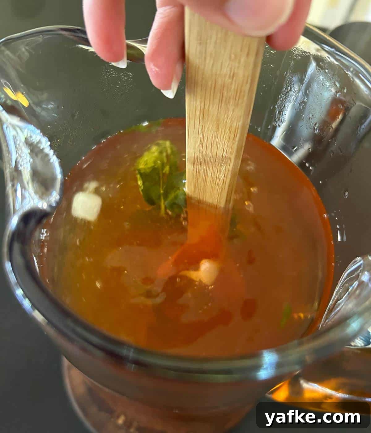Stirring mint iced tea.