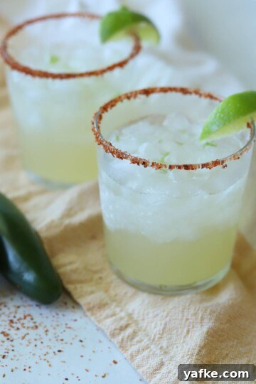 Lime margaritas with Tajín rim and lime wedges.