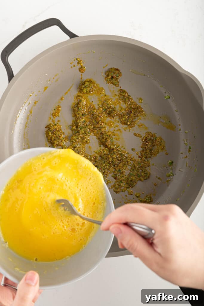 Eggs pouring into a pan
