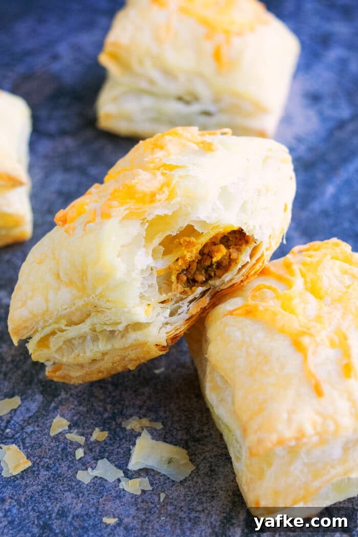 One-Pan Ground Beef Puff Pastry Pie 4 Partially Eaten Mexican Meat Puff Pastry or Puffs on Rustic Gray Background