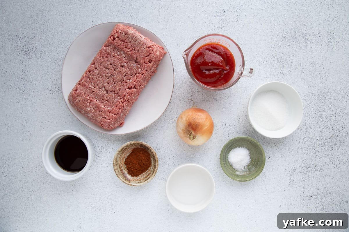 Classic Old Fashioned Sloppy Joes Sandwich Recipe 3 ground beef, ketchup, and small bowls of other ingredients on a white table.