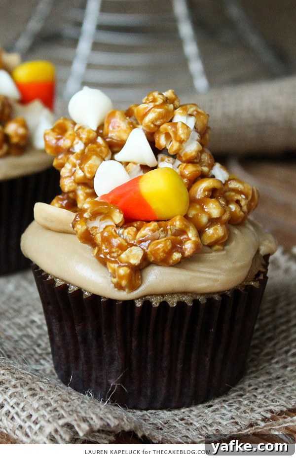 Caramel Corn Cupcakes for Halloween - caramel cupcakes topped with caramel frosting and caramel popcorn studded with candy corn and cashews | by Lauren Kapeluck for TheCakeBlog.com