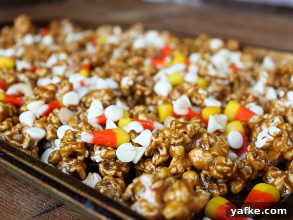 Caramel Corn Cupcakes for Halloween - caramel cupcakes topped with caramel frosting and caramel popcorn studded with candy corn and cashews | by Lauren Kapeluck for TheCakeBlog.com