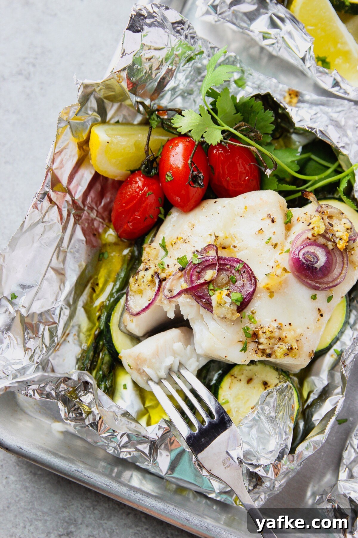Foil-Baked Fish with Lemon, Garlic and Seasonal Vegetables 5 fish in foil with vegetables